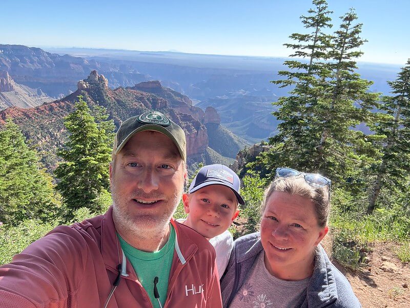 Selfie frontal haute résolution pris par l'iPhone 16 : netteté des visages au premier plan et qualité des détails du paysage montagneux de l'Arizona en arrière-plan.
