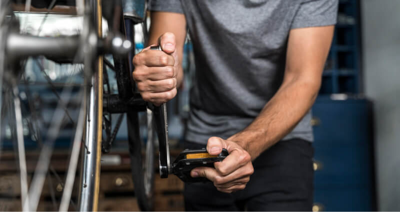 Jeune homme en train de réparer son vélo lui-même